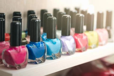 Bottles of multi-colored beautiful nail polish, placed in a row Stock Photos