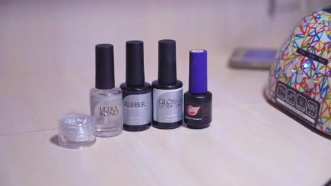 Bottles of nail polish are on the table. a lamp for drying nails. tools for Stock Footage 87190239