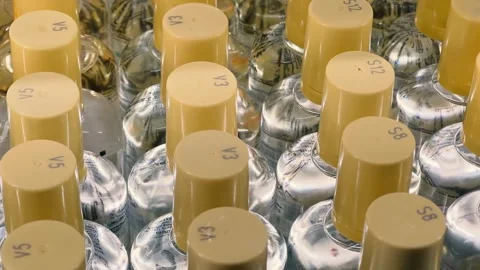 Bottles of niche perfumes lined up in rows on a perfume store shelf Stock Footage 258701789