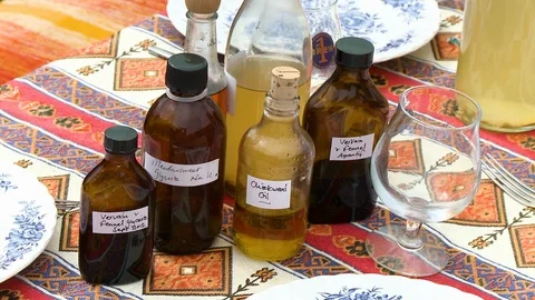 Bottles Of Oil On Table Stock Footage 115804760