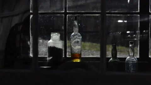 Bottles in  old cabin window, backlit Video stock 152272481