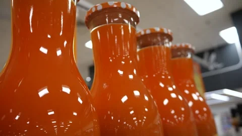 Bottles with orange juice close-up. Vídeo Stock 267931606