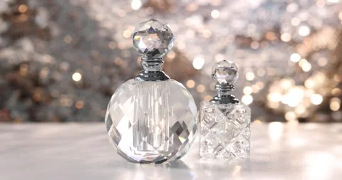 Bottles of perfume on white table against shiny background Stock-Footage 304920434