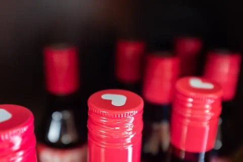 Bottles with red corks and with a pattern of a white heart. soft focus effect Stock Photos