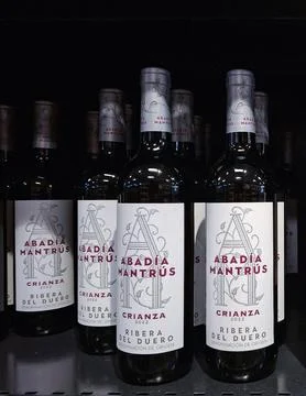 Bottles of red wine from Spain on display in a supermarket in Denia, showca.. Stock Photos