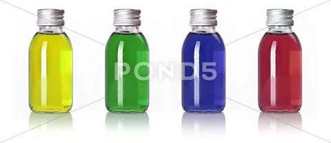 Bottles in a row with colored liquid Stock Photos