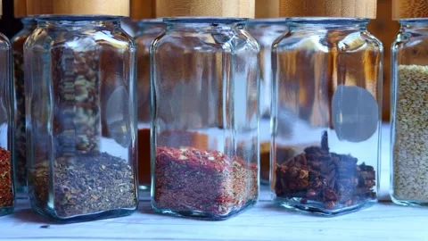 Bottles of spices adorn the table, offering a rich array of flavors. Explore the Stock Footage 268971085