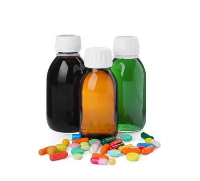 Bottles of syrups with pills on white background. Cough and cold medicine Stock Photos