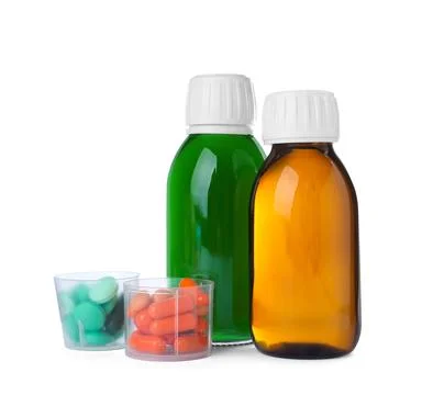 Bottles of syrups with pills on white background. Cough and cold medicine Stock Photos
