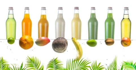 Bottles with various fruit drinks and tropical fruits on the water surface. Stock Photos