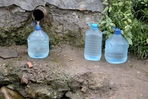 Bottles with water from a spring Stock Photos