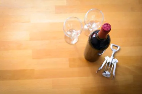 Bottles of wine with a corkscrew on wood table Stock Photos