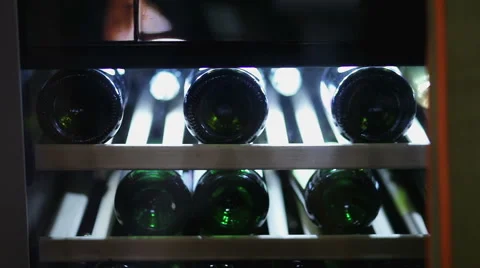 Bottles in the wine refrigerator Stock Footage 60563619