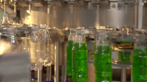 Bottling of lemonade in plastic bottles. Lemonade bottle conveyor industry. Video stock 76347578