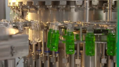 Bottling of lemonade in plastic bottles. Lemonade bottle conveyor industry. Video stock 76348179
