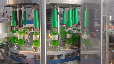 Bottling of lemonade in plastic bottles. Lemonade bottle conveyor industry. Video stock 76348499