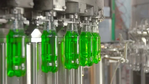 Bottling of lemonade in plastic bottles. Lemonade bottle conveyor industry. Stock Footage 76349006