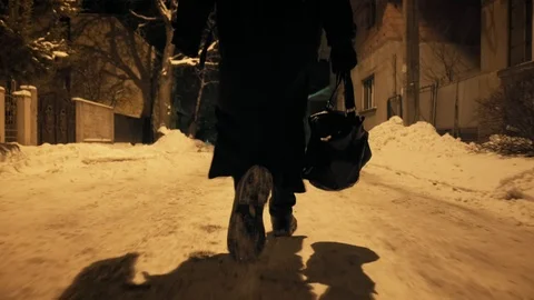 Bottom angle: Man ib black cloak walking through alley Stock-Footage 103364799