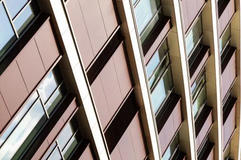 Bottom angular view of building with maroon walls and windows Foto stock