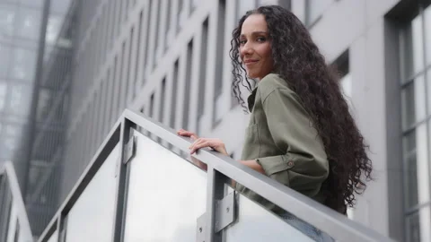Bottom back view 30s Caucasian Hispanic businesswoman lady with curly hair Stock Footage 205217948