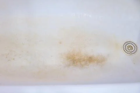 The bottom of the bath, which is covered with rust. Stock Photos