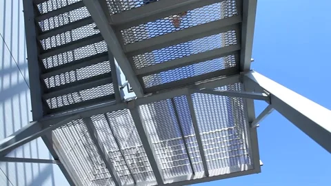 Bottom camera 360 degree view on man in suit using climbing modern architecture  Stock Footage 137540650