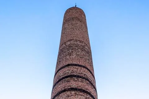 Bottom close shoot of masonry brick factory chimney at summertime Stock Photos
