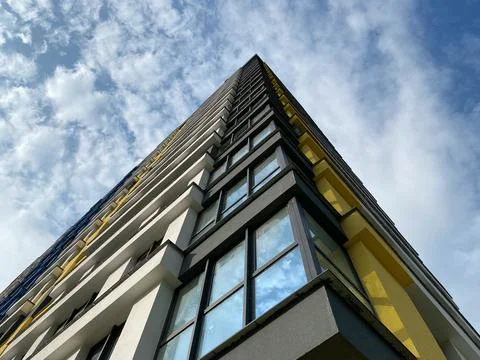 Bottom up corner view of a tall large house of a new building against a backg Fotos de archivo