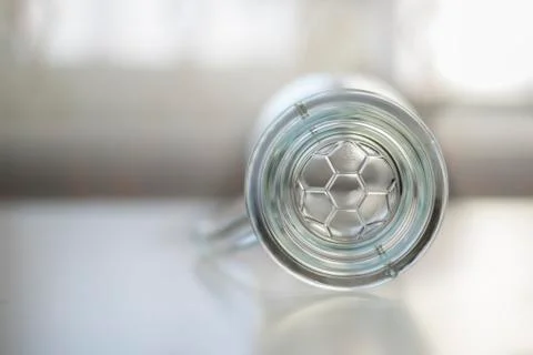 The bottom empty glass beer mug with soccer ball on white table Stock Photos