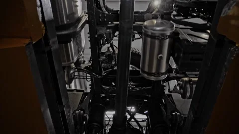Bottom of the engine, driveshaft and chassis of a moving freight truck. Stock Footage 261285802