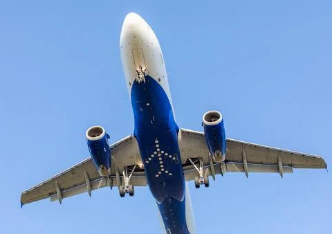 Bottom of a flying Plane in the sky Stock Photos
