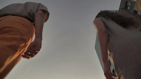 Bottom frame of contact between a walking guy and a girl Stock Footage 135736450