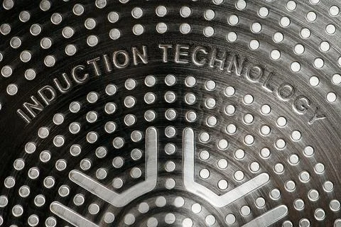 Bottom of induction cookware. Texture of a non-stick induction pan close-up Stock Photos
