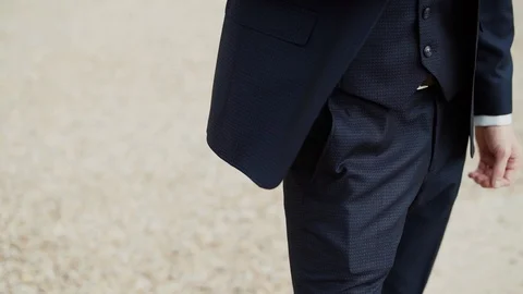 The bottom of male blue jacket develops in wind on standing caucasian man Video stock 129074774