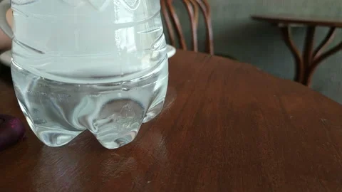 Bottom part of Plastic Pet Bottle at table Stock Footage 112384217