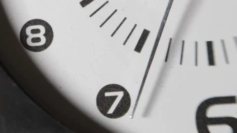Bottom Part of White Faces Clock with Metal Arrow Ticking upon Black Stock Footage 153260846