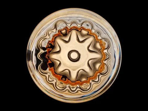 The bottom of the patterned glass beer mug on a black background Stock Photos