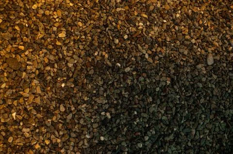 The bottom of the pond is covered with small pebbles. Playful colors of stones Stock Photos