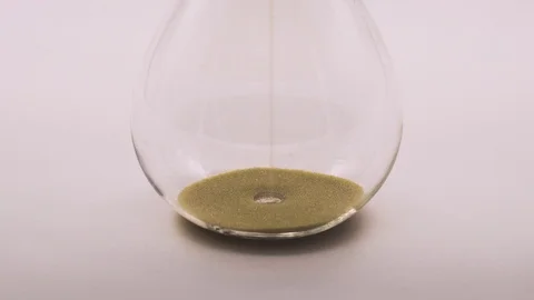 The bottom of a sand glass working in real time. Stock Footage 119694376