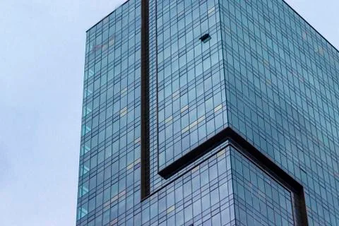 Bottom shoot of blue colored high-rise building with glass facade Stock Photos