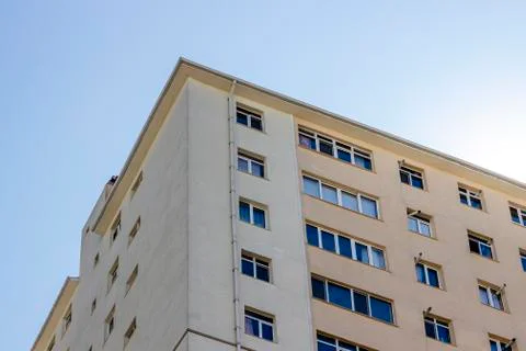 Bottom shoot of concrete structured mass housing clear yellow colored facade Stock Photos