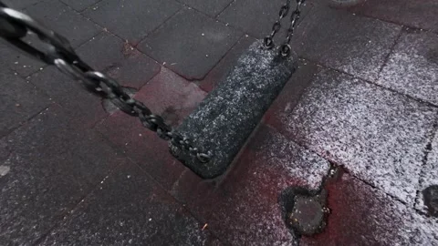 Bottom-to-Top moving camera, Moody View of a Swing on Chains While Snowing Stock Footage 304262714