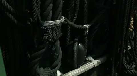 A bottom to top panning shot of a sailing ship's inner deck with black ropes Vídeo Stock 61280726
