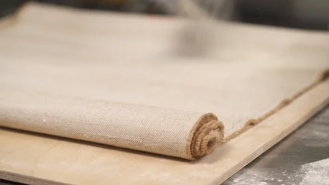 A bottom top shot of the professional chef hand powdering a piece of cloth with Stock Footage 106254781