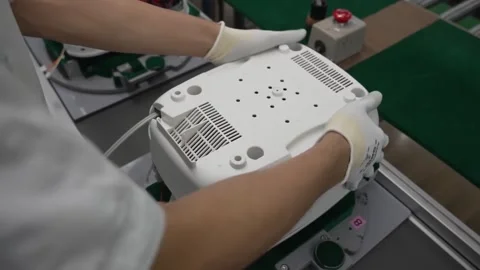Bottom view of assembled white rice cooker showing ventilation grilles and Stock Footage 334965577