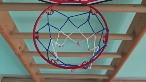 Bottom view of a basketball going through the net. The red, white, and blue net Stock Footage 346316964