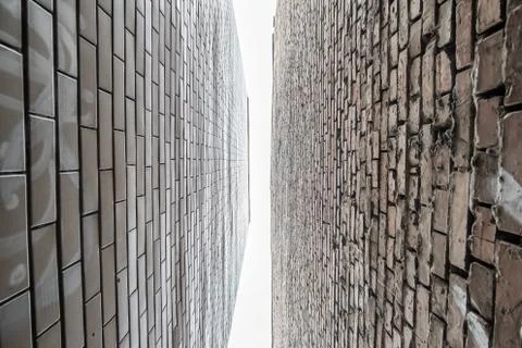 Bottom-up view between two brick walls, located close to each other during th Stock Photos