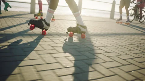 Bottom view of a black woman rollerskating on the broadwalk Stock Footage 279340513