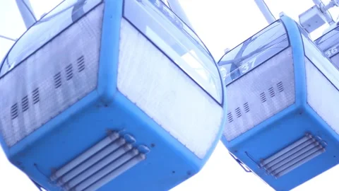Bottom view. Blue ferris wheel cabin passes in front of camera Stock Footage 326825591