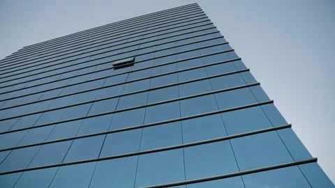 Bottom view of blue high modern office building with glass windows with one open Stock Footage 221427659